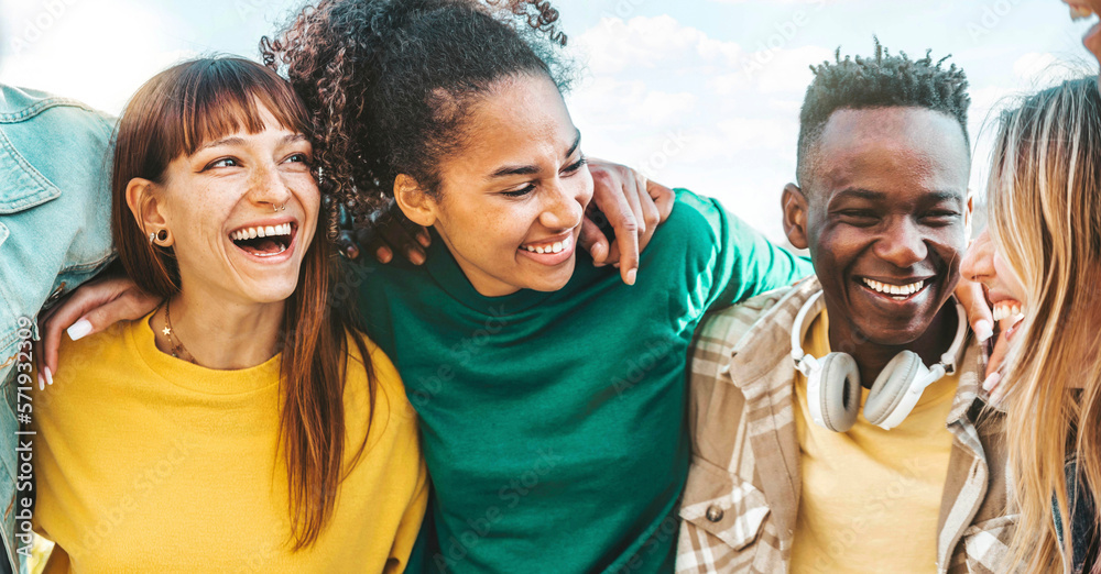 Happy multicultural enjoying summer vacation outdoors - Smiling group of friends having fun walking 