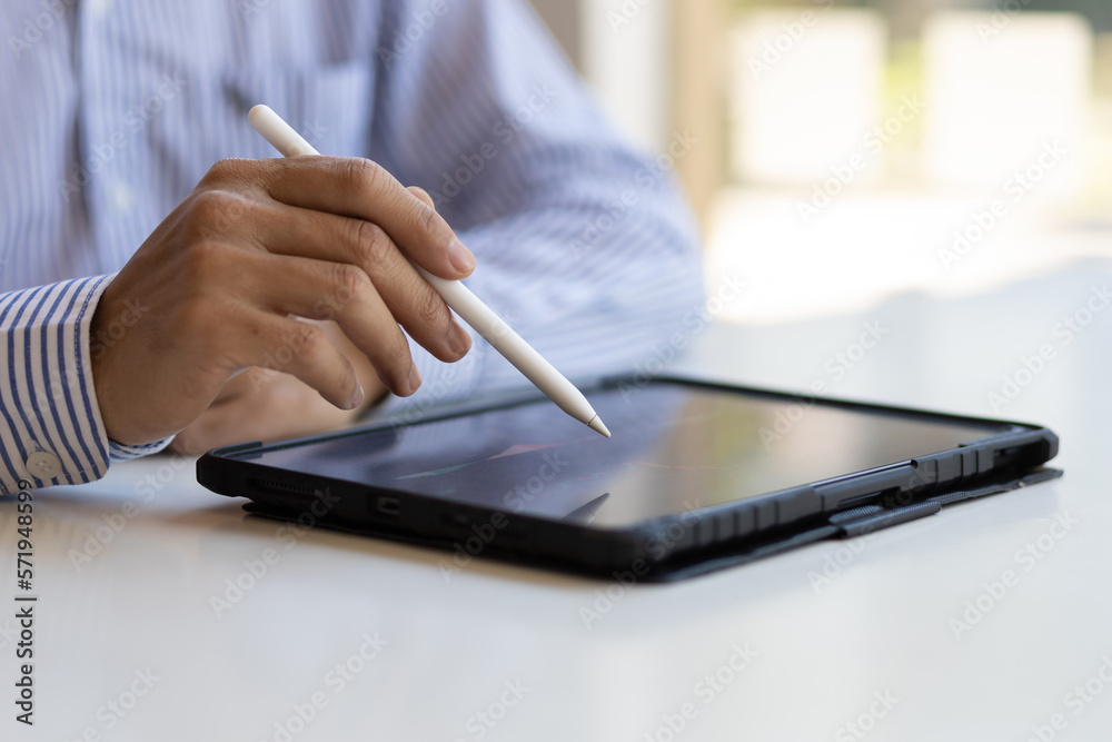 Businessman working on tablet analysis stock market investment graph. Investors analyzing stock mark