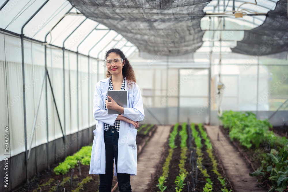 Portrait of Woman agricultural researcher holding tablet while working on research at plantation in 