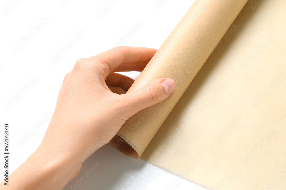 Female hand with roll of baking paper isolated on white background, closeup