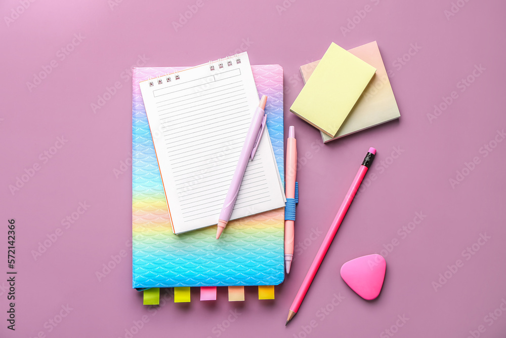 Set of stationery with notebooks on lilac background