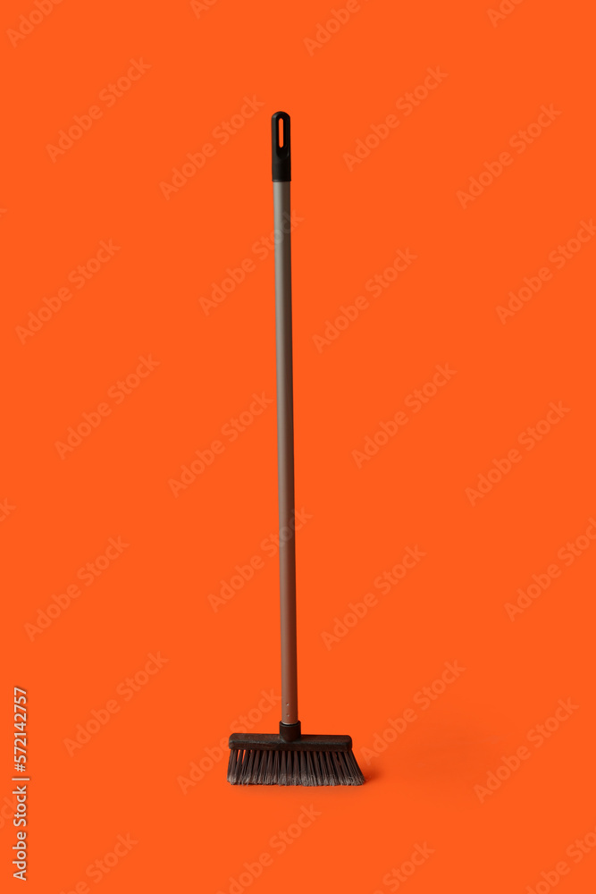 Plastic cleaning broom on color background