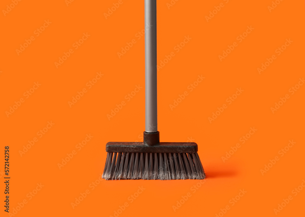 Plastic cleaning broom on color background