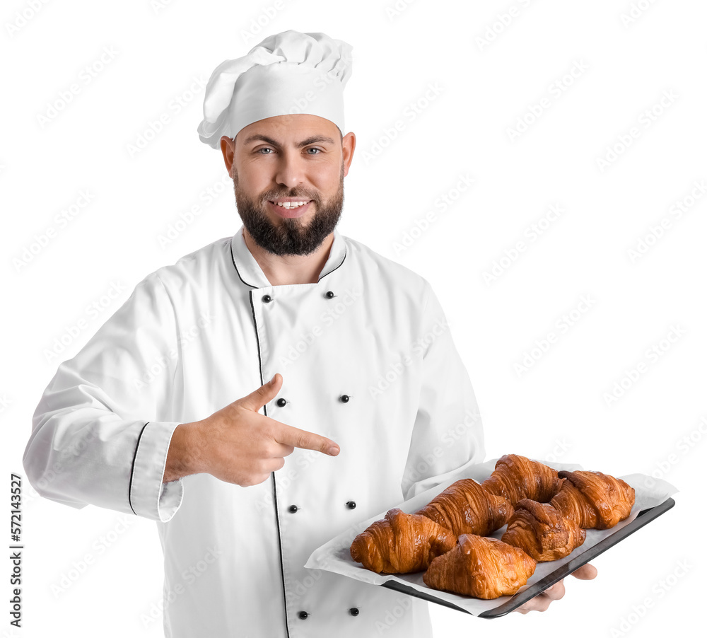 Male baker pointing at tray of tasty croissants on white background