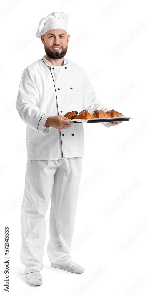 Male baker with tray of tasty croissants on white background