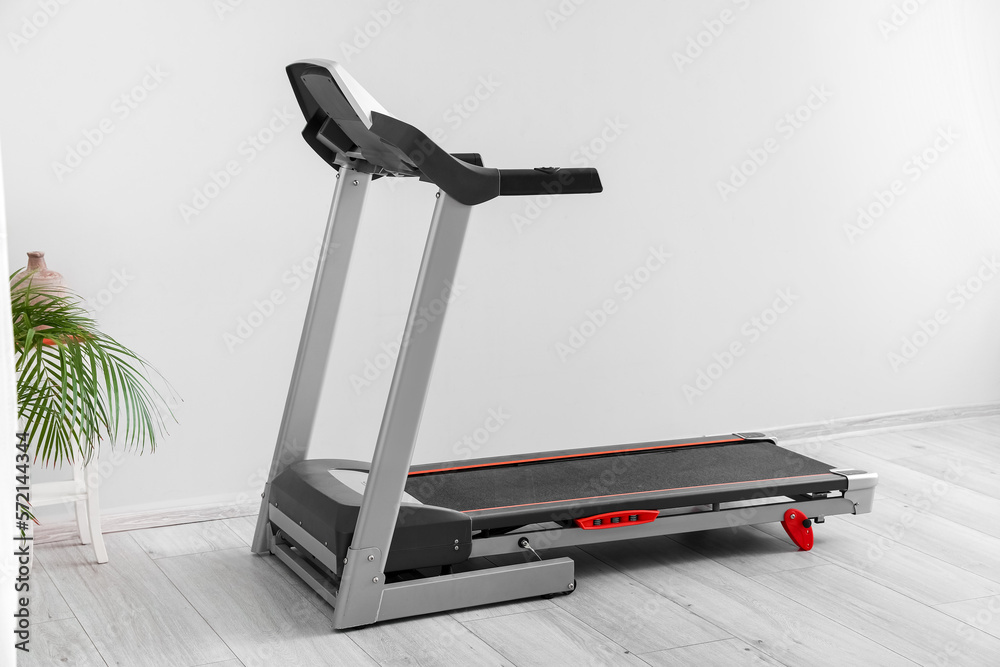 Modern treadmill in light room