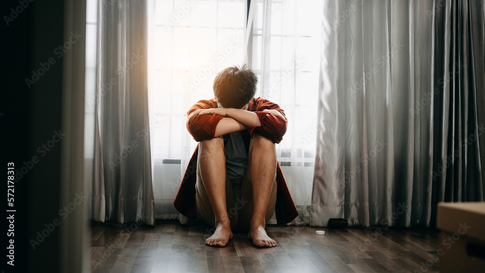 Asian Man sit Depression Dark haired  pensive glance Standing by window and anxiety Copy space.