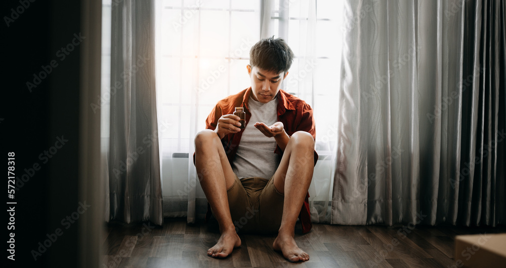 Asian Man sit Depression Dark haired  pensive glance Standing by window and anxiety Copy space.