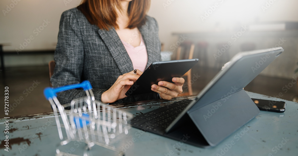 Woman using smart phone for mobile payments online shopping,omni channel,sitting on table,virtual ic