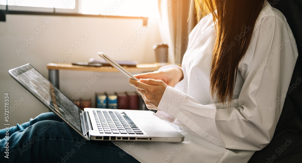 Woman using smart phone for mobile payments online shopping,omni channel,sitting on table,virtual ic