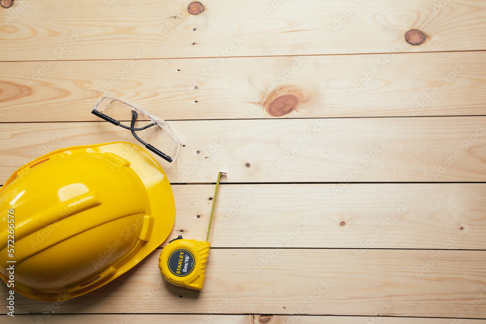 Work safety. Standard Construction site protective equipment on  top view wooden background, flat la