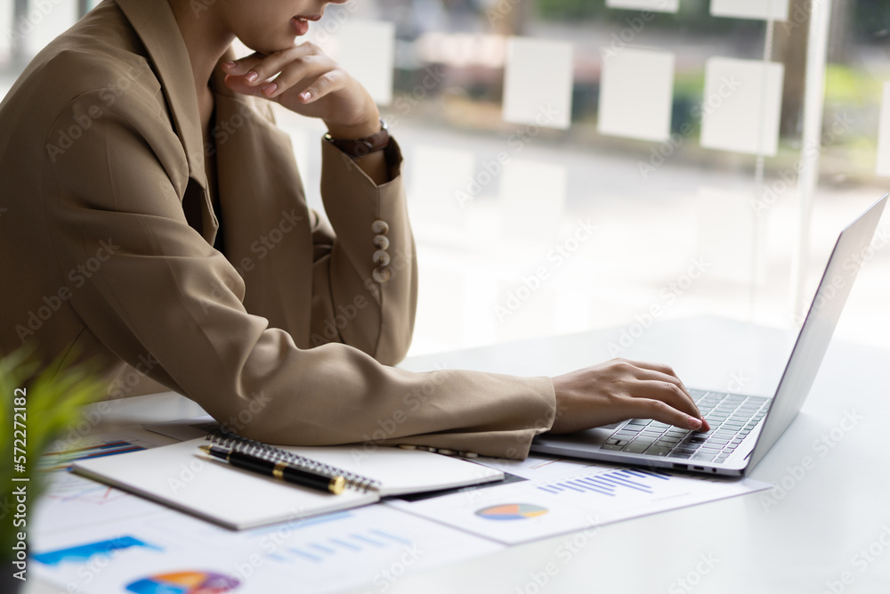 Businesswoman working with financial accounting documents in the office.