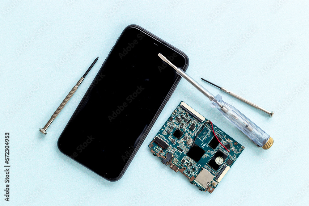 Electronics servise and repair concept - mobile phone with circuit board