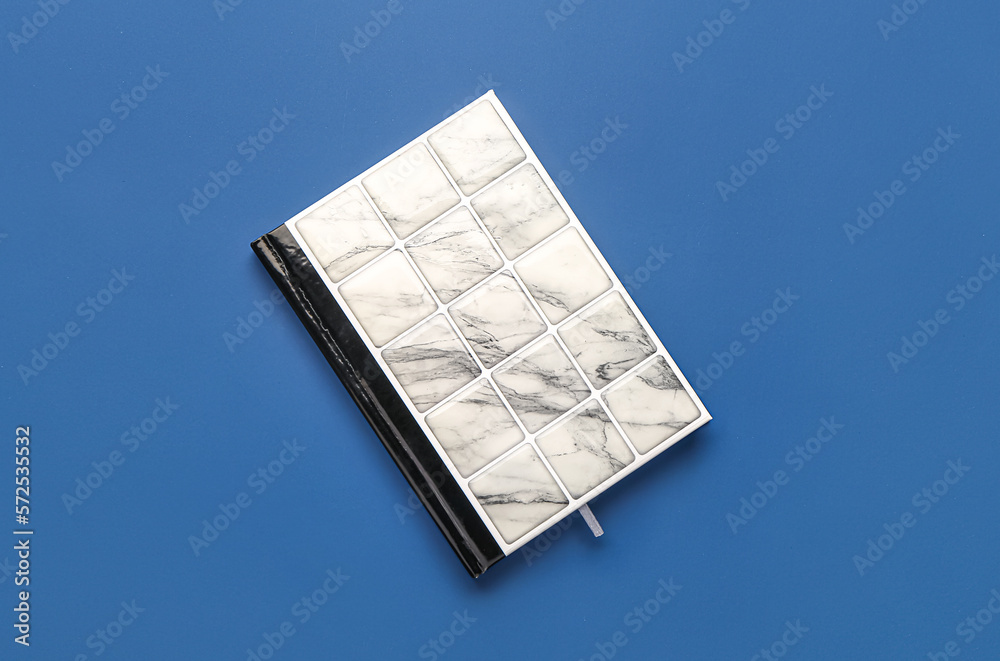 Stylish notebook on blue background