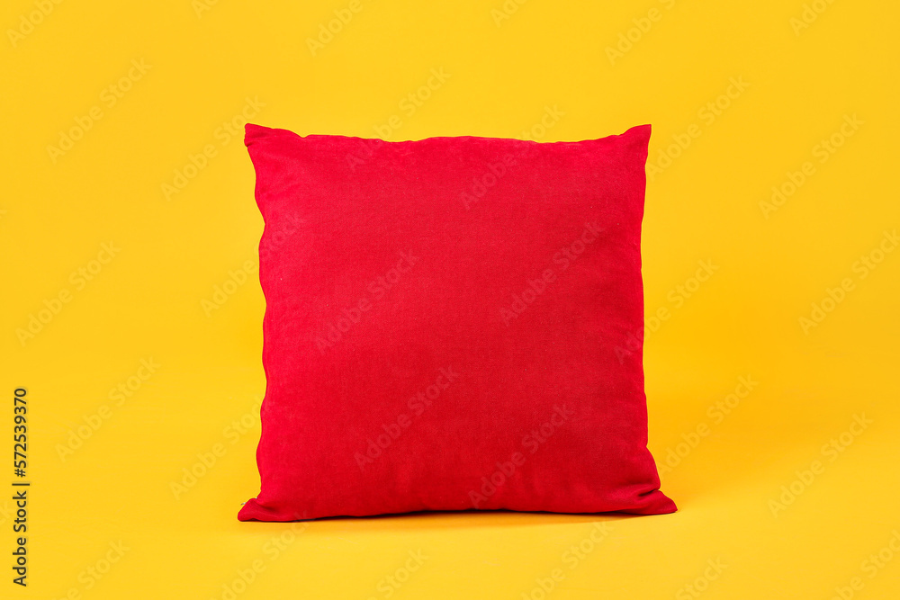 Red pillow on yellow background