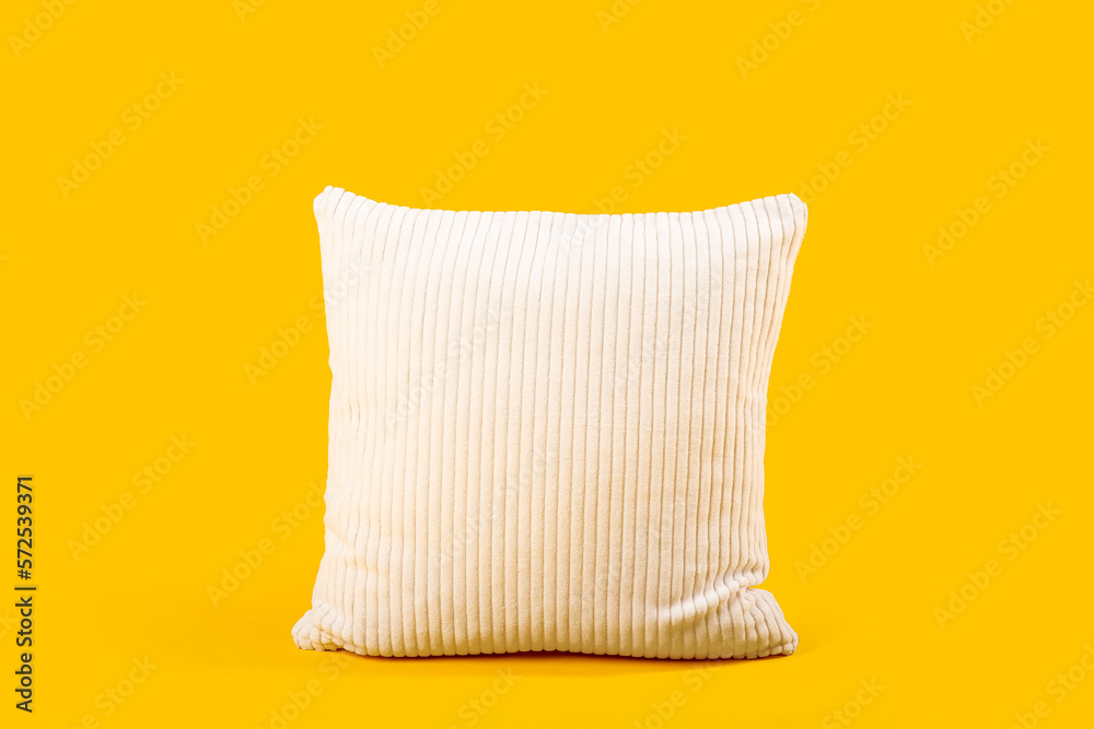 Soft pillow on yellow background