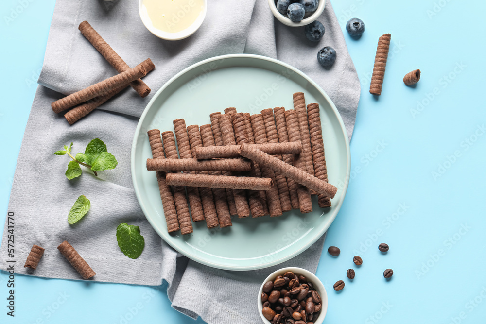 Composition with delicious chocolate wafer rolls, blueberries, coffee beans, condensed milk and mint