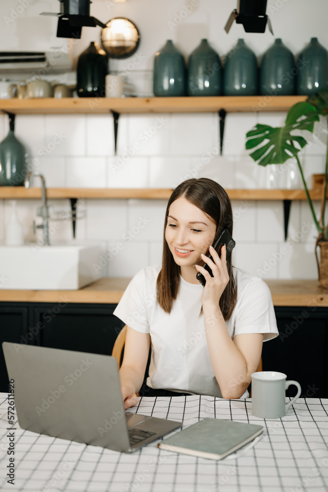 Business woman have the joy of talking on the smartphone, tablet and laptopon the home office