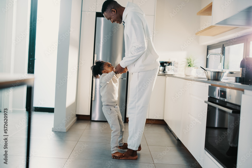 Dad and daughter dancing in the kitchen