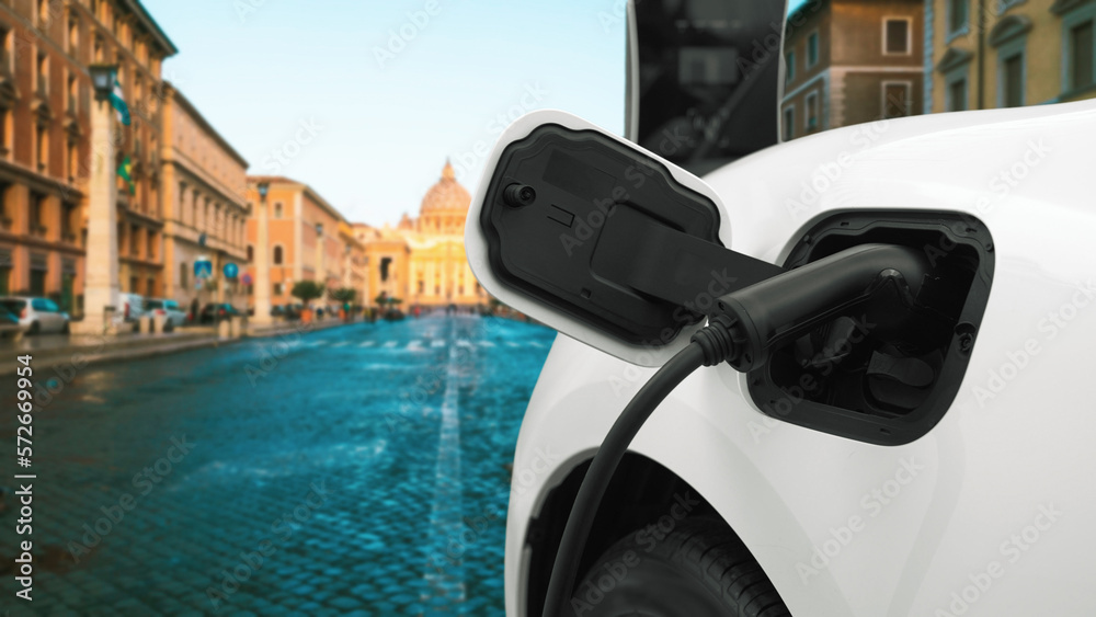 Progressive electric car recharging battery at the charging station in Vatican, historical christian