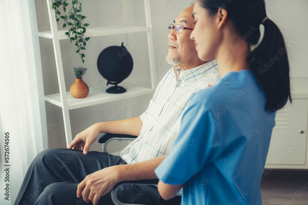 Caring nurse and a contented senior man in a wheel chair at home, nursing house. Medical for elderly