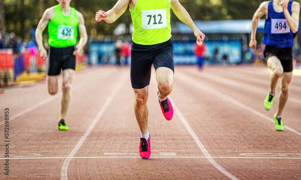 winning finish man runner athlete sprint race at stadium