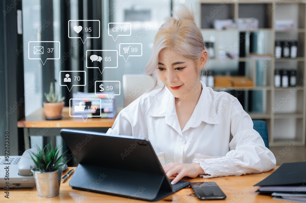 Asian woman typing smartphone, keyboard  with laptop computer of Social media and Marketing virtual 