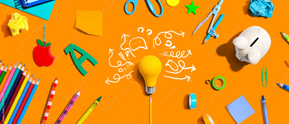 Brainstorming concept with a light bulb and school supplies - Flat lay