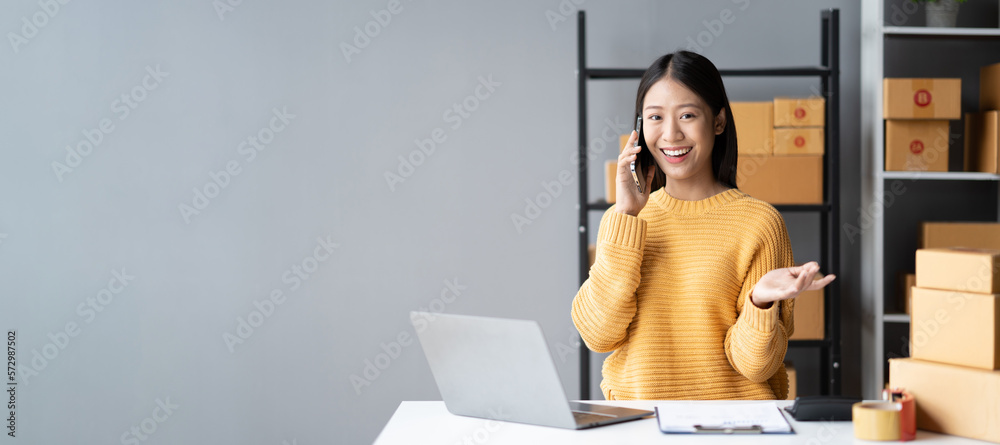 Young Sme business owner having a conversation with her customer on the phone, get more details befo