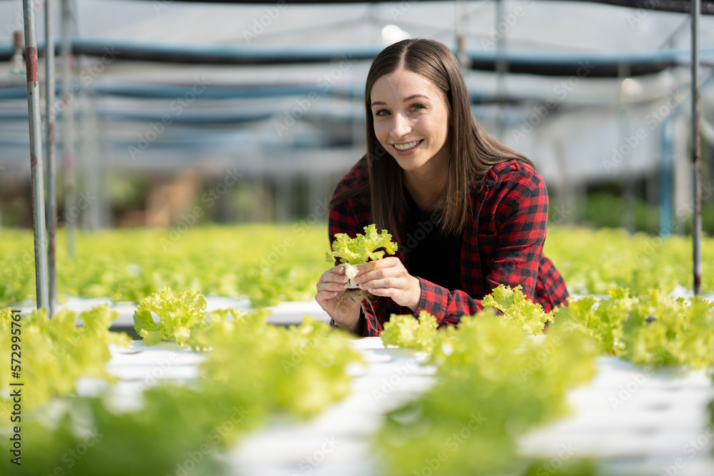 Portrait of young caucasian working in vegetables hydroponic farm with happiness.