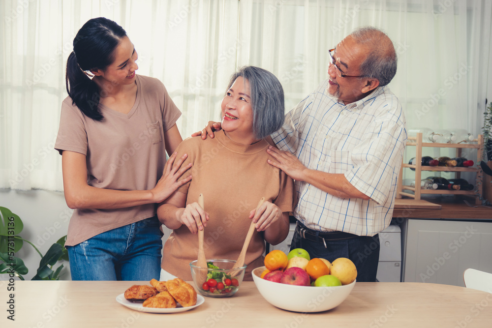 Contented family, daughter, father, mother prepare bread veggies and fruit salad together in their k