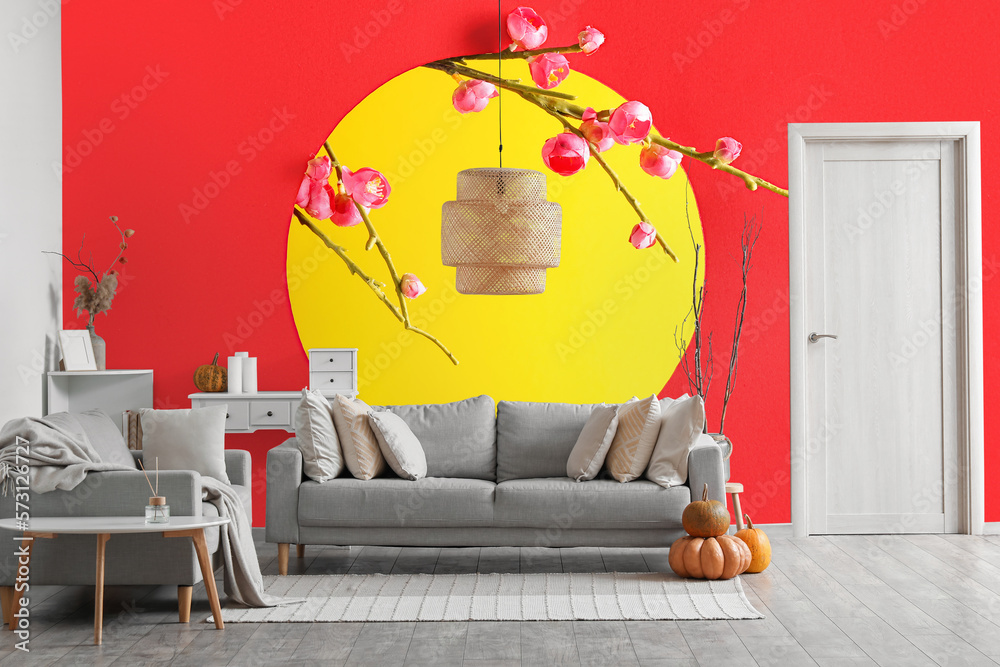 Interior of trendy living room with grey sofas and beautiful Chinese print on wall