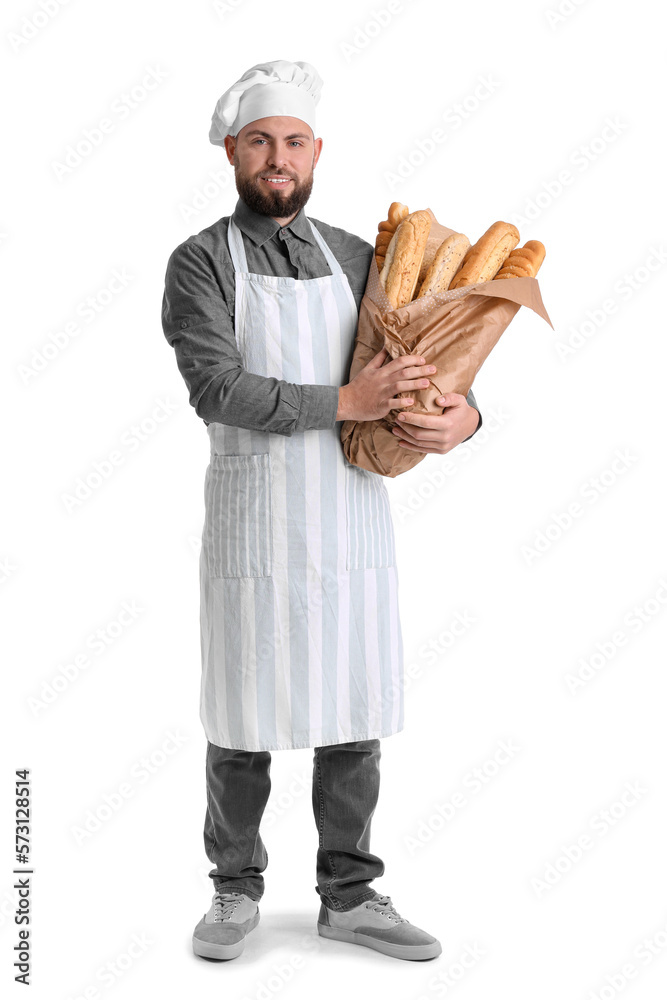 Male baker with fresh baguettes on white background