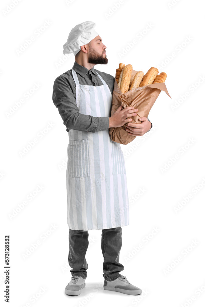 Male baker with fresh baguettes on white background