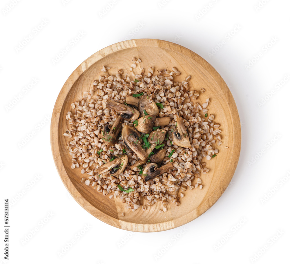 Wooden plate of tasty buckwheat porridge with mushrooms and dill isolated on white background