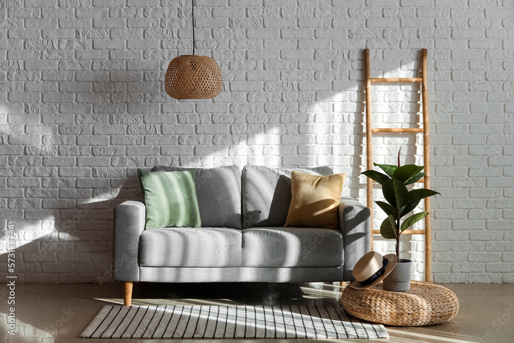 Interior of living room with grey couch and ladder