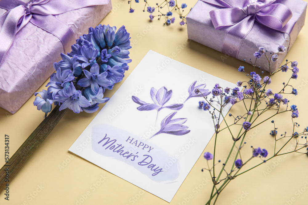 Composition with greeting card, beautiful flowers and gifts for Mothers day celebration on color ba