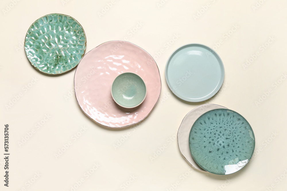 Set of stylish ceramic plates on light background