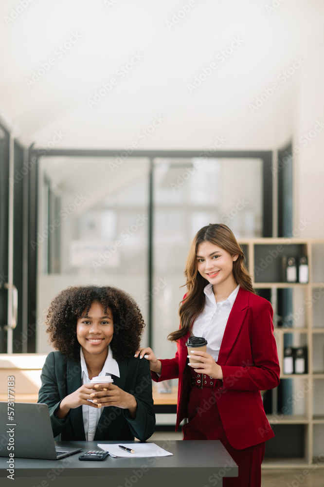 Two asia business working together with laptop on office desk in office room sitting at coffee shop.