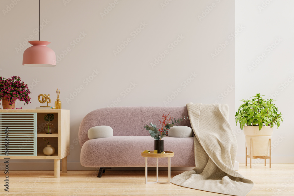 Wall mockup with pink sofa and accessory decor in living room.