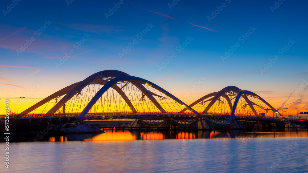 A bridge in the city at night. The bridge on the blue sky background during the blue hour. Architect