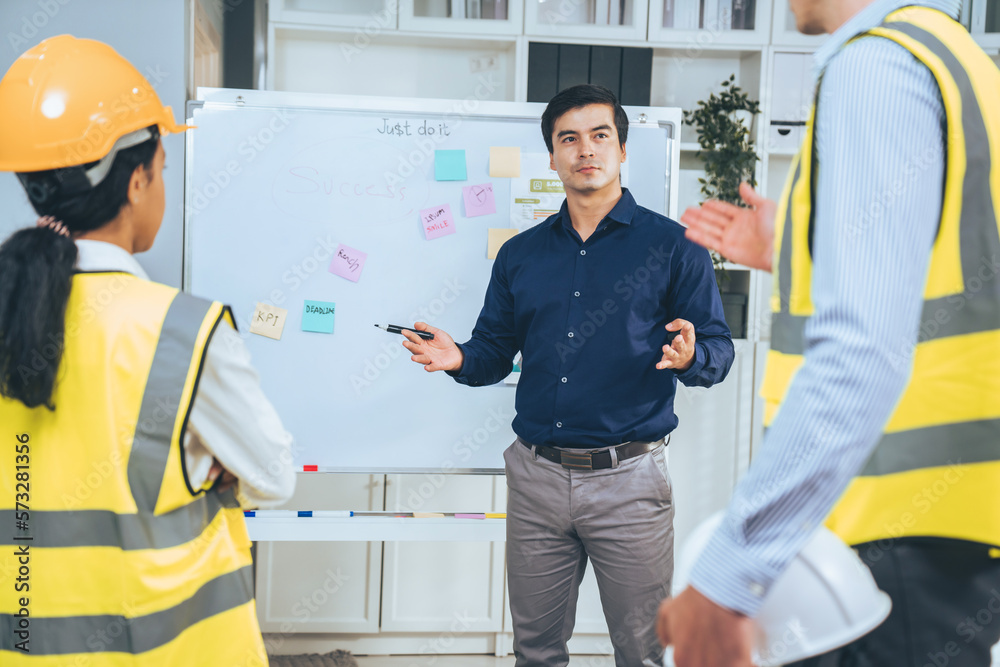 A team of investor and competent engineers brainstorming on the whiteboard to find new ideas and mak