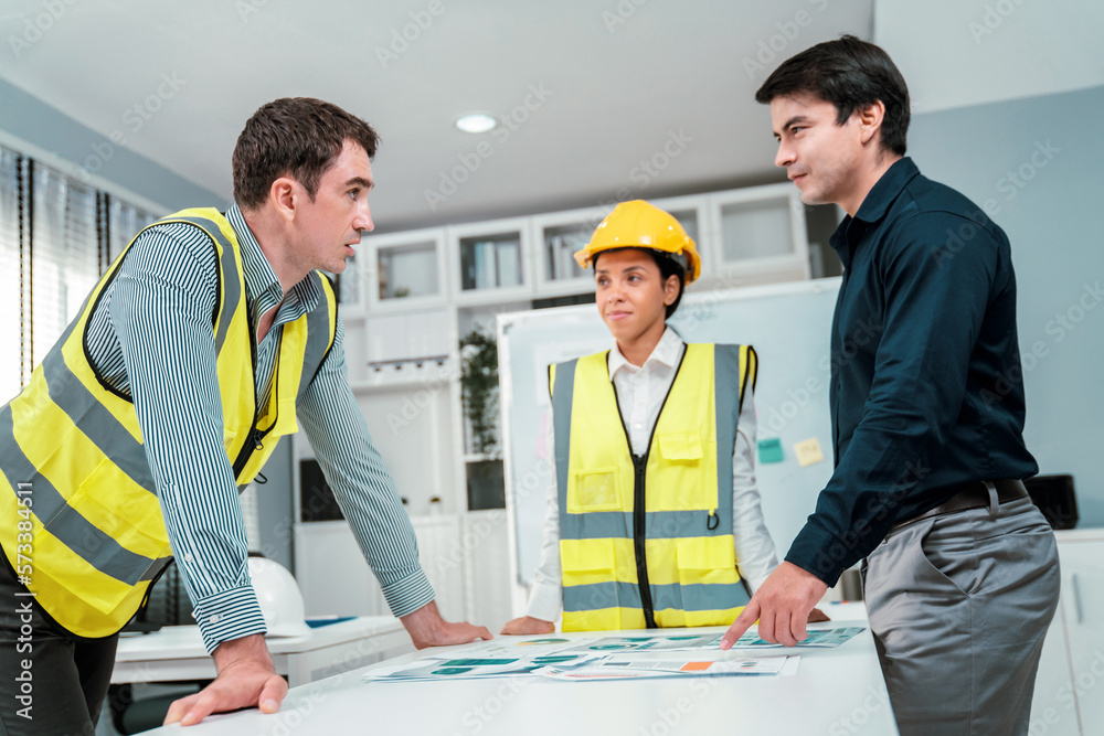 A group of competent engineers and employer discuss plans in the office. Architectural investor, bus