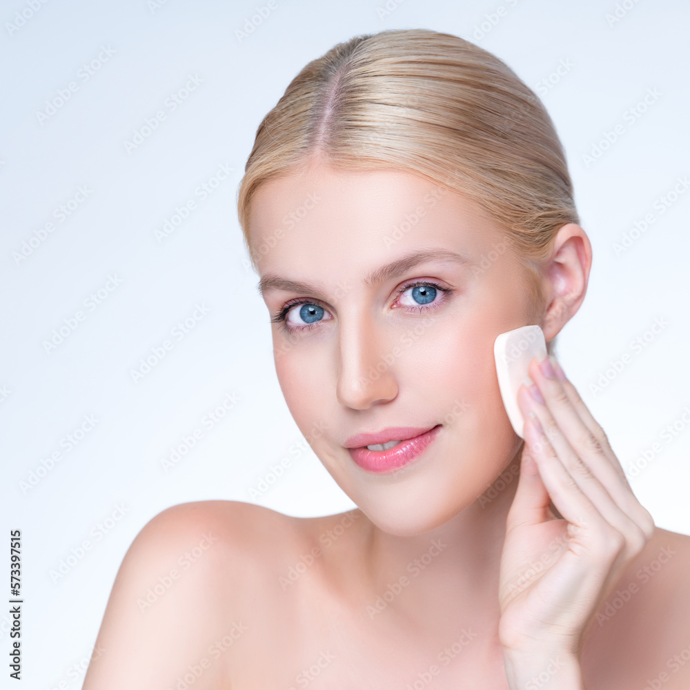 Closeup personable beautiful natural soft makeup woman using powder puff for facial makeup concept. 