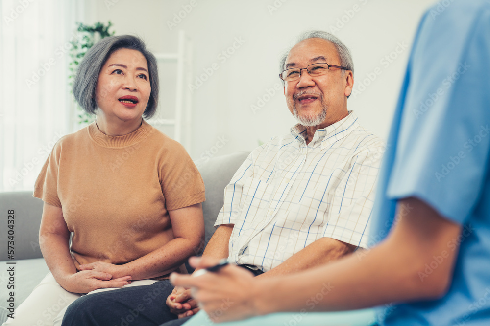 Female doctor visiting a contented elderly couple at their home. Health care, senior health support 