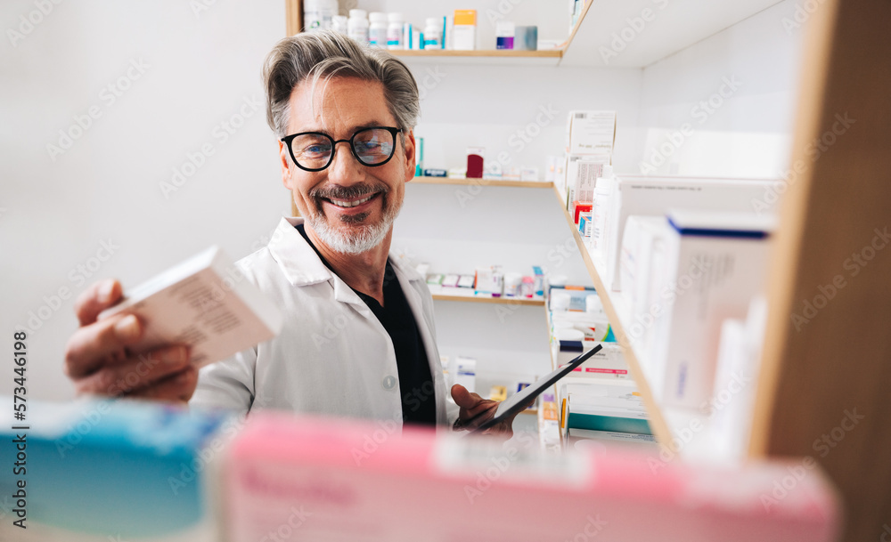 Pharmacist reading a medication label in a chemist