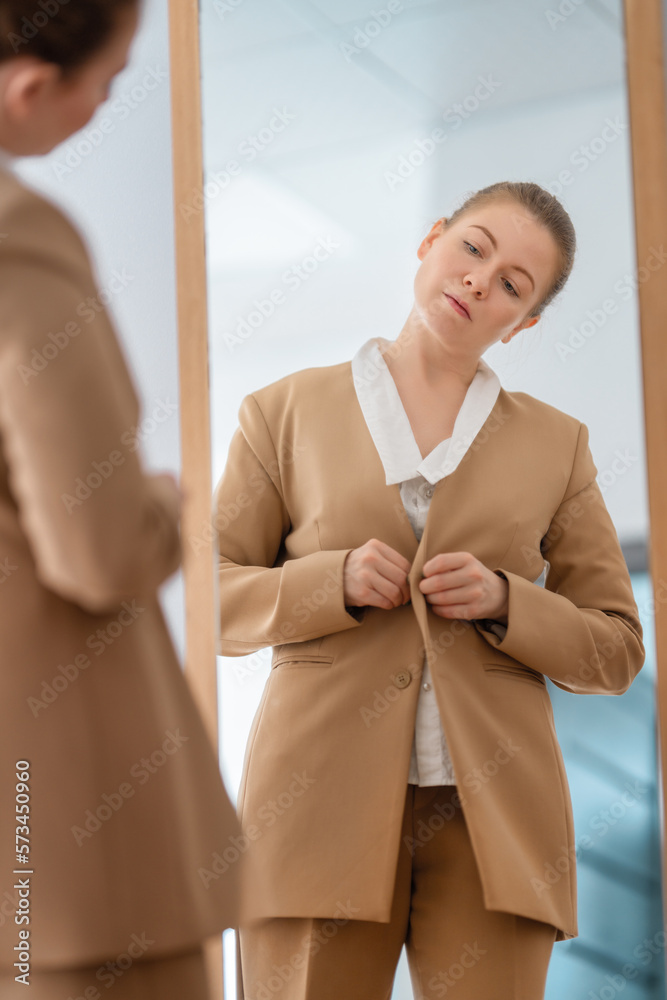 woman looking at her reflection in mirror