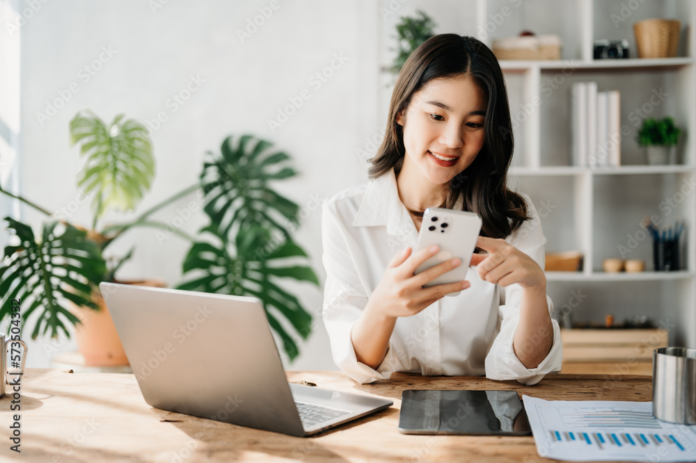  Working woman concept a female manager attending video conference and holding tablet, smatrphone an