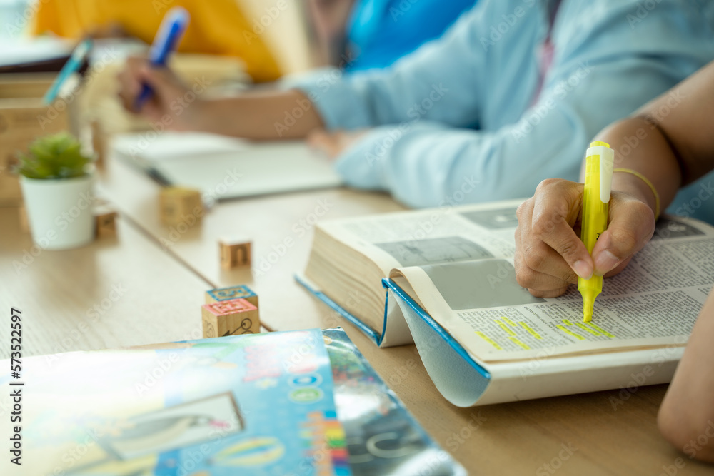 Black girl are taking test in elementary classroom school with diverse group of bright children work