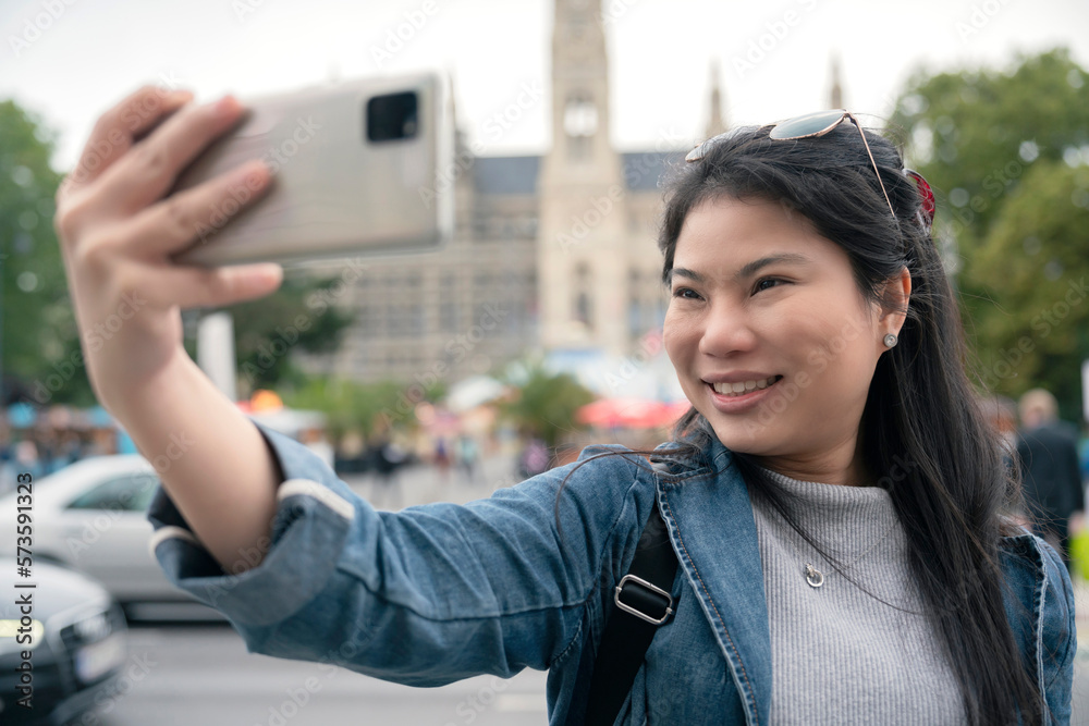 asian female woman  traveller enjoy holiday vacation city walking hand using smartphone taking photo